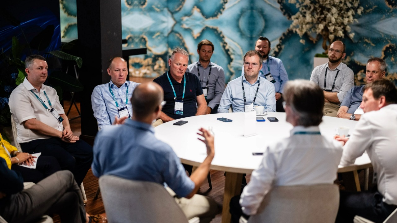Group of men sitting around a table at Realize LIVE for the Path Makers Program.