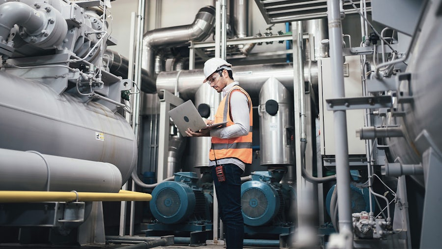 Engineering in a smart manufacturing facility for pharmaceuticals conducting predictive maintenance.