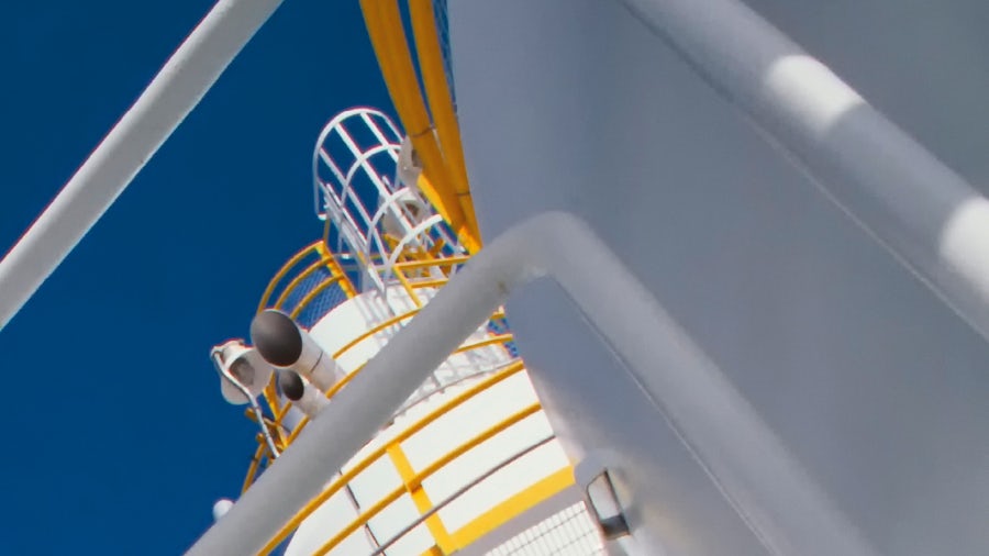 White oil tanks with yellow walkway