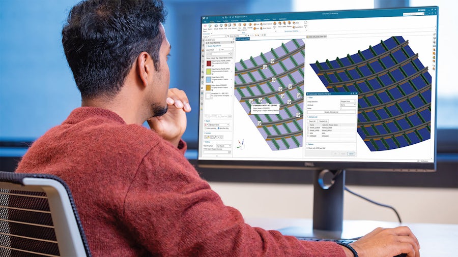 Engineer at computer screen making a large finite element mesh model for an automotive body.