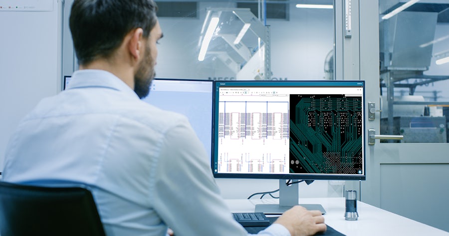 bearded man looking at monitor