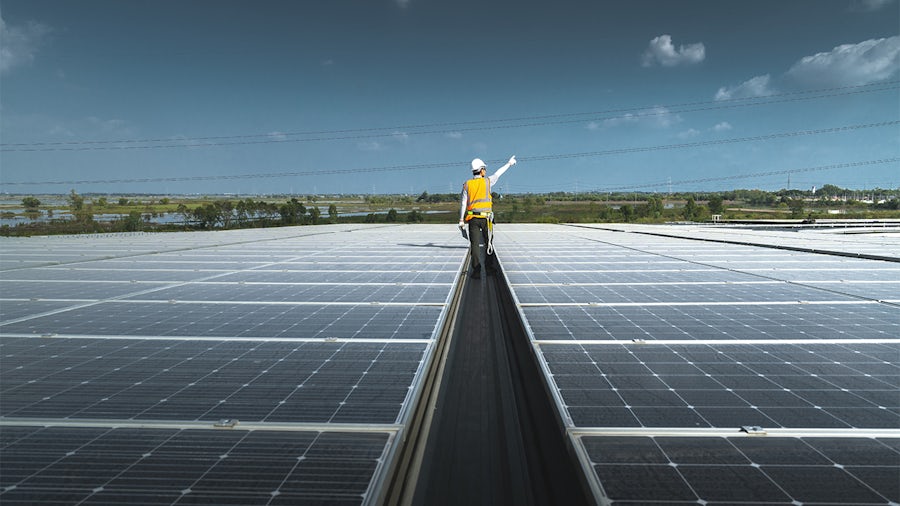 A modern gigafactory with elements like solar panels, construction cranes and interconnected supply chains, symbolizing optimized infrastructure for increased battery production capacity and cost efficiency.