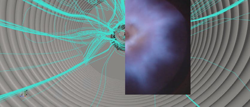 Aerial view of engineer walking through power plant holding a digital tablet.