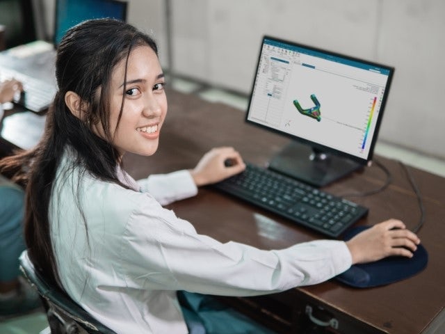 A girl using NX Performance Predictor on a desktop computer.
