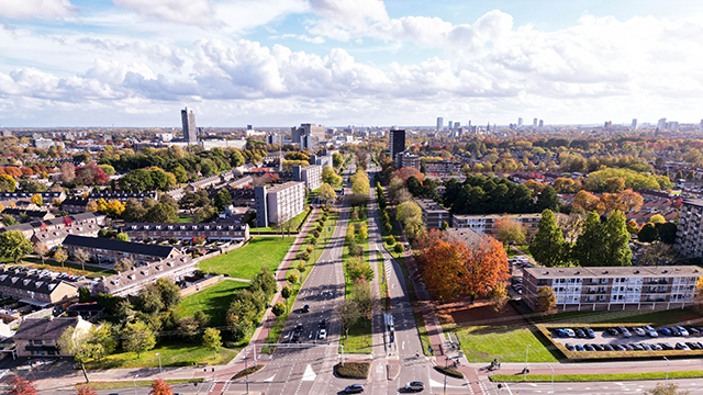 Aerial view of vibrant urban Eindhoven, Netherlands, cityscape, featuring multiple buildings and trees.
