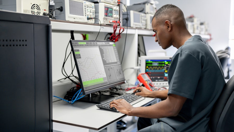 Engineer in the lab assessing the power consumption of an SoC.