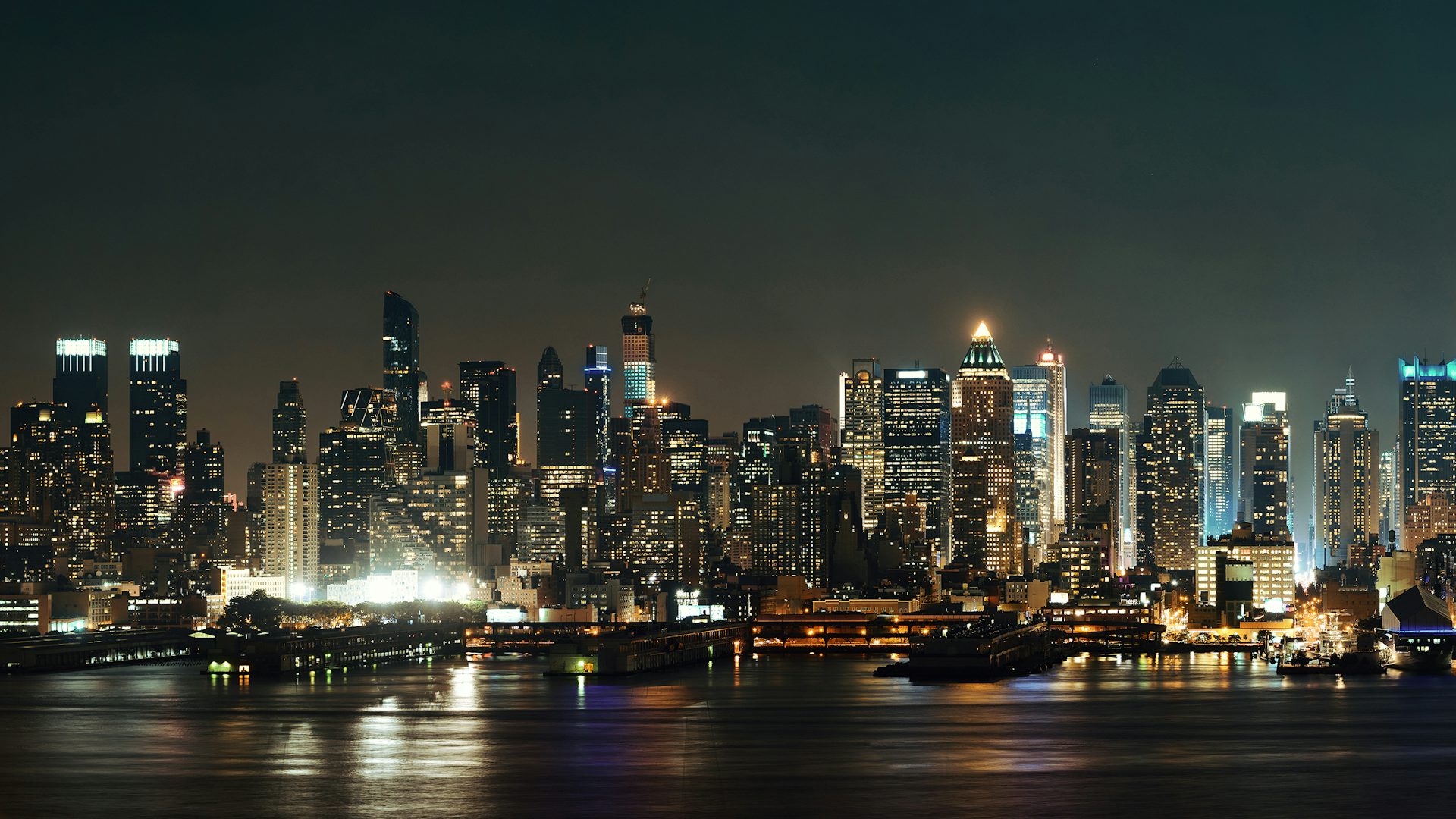 Midtown Manhattan skyline at dusk panorama over Hudson River.