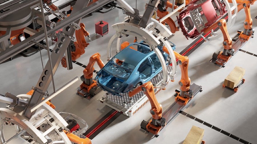 A blue car and a red car move along an automatedassembly line as orange machines add parts to the cars.