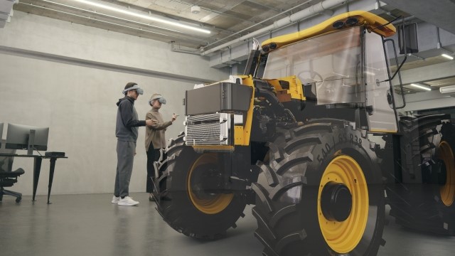 Two engineers wearing Sony XR head-mounted displays and using the accompanying controllers to manipulate a virtual design in extended reality (XR)/VR.