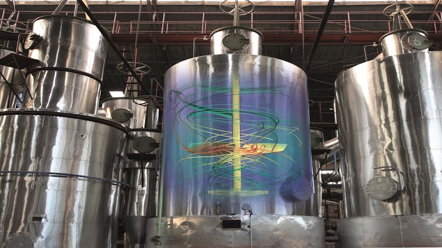A big metal structure in a chemical plant for industrial processes.
