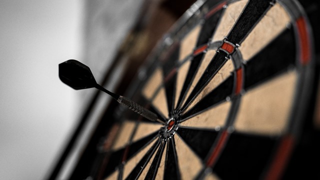 Dartboard with dart in the bullseye