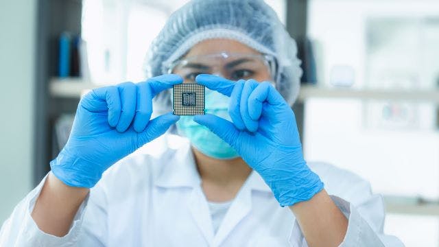 Person holding a semiconductor.