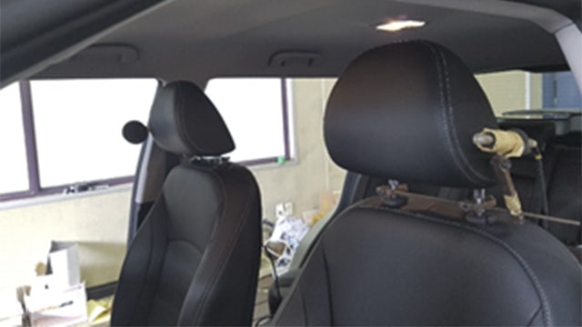 Noise vibration harness device setup inside the car to optimize NVH testing.