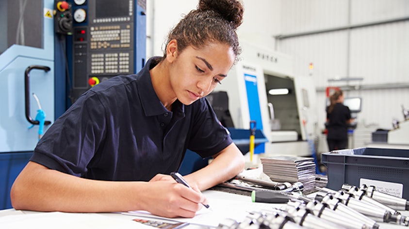 An quality inspection planning employee looking over the inspection plan management document.