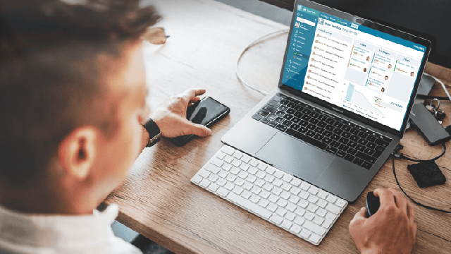 A man works in Siemens Polarion on his laptop.