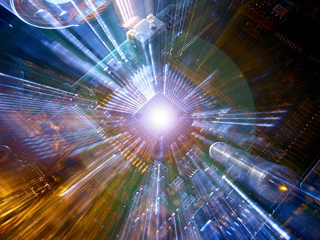 Light beams shoot upwards from an integrated circuit.