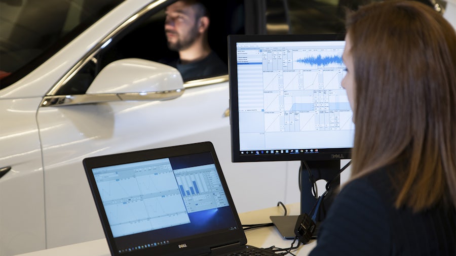 A couple of engineers are performing the active sound test.