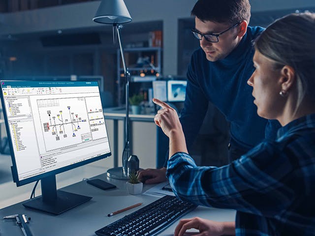 two engineers review the latest design specs before publishing